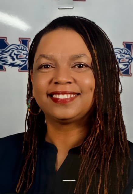 Smiling woman with long dark locs and hoop earrings against a white background with logos.